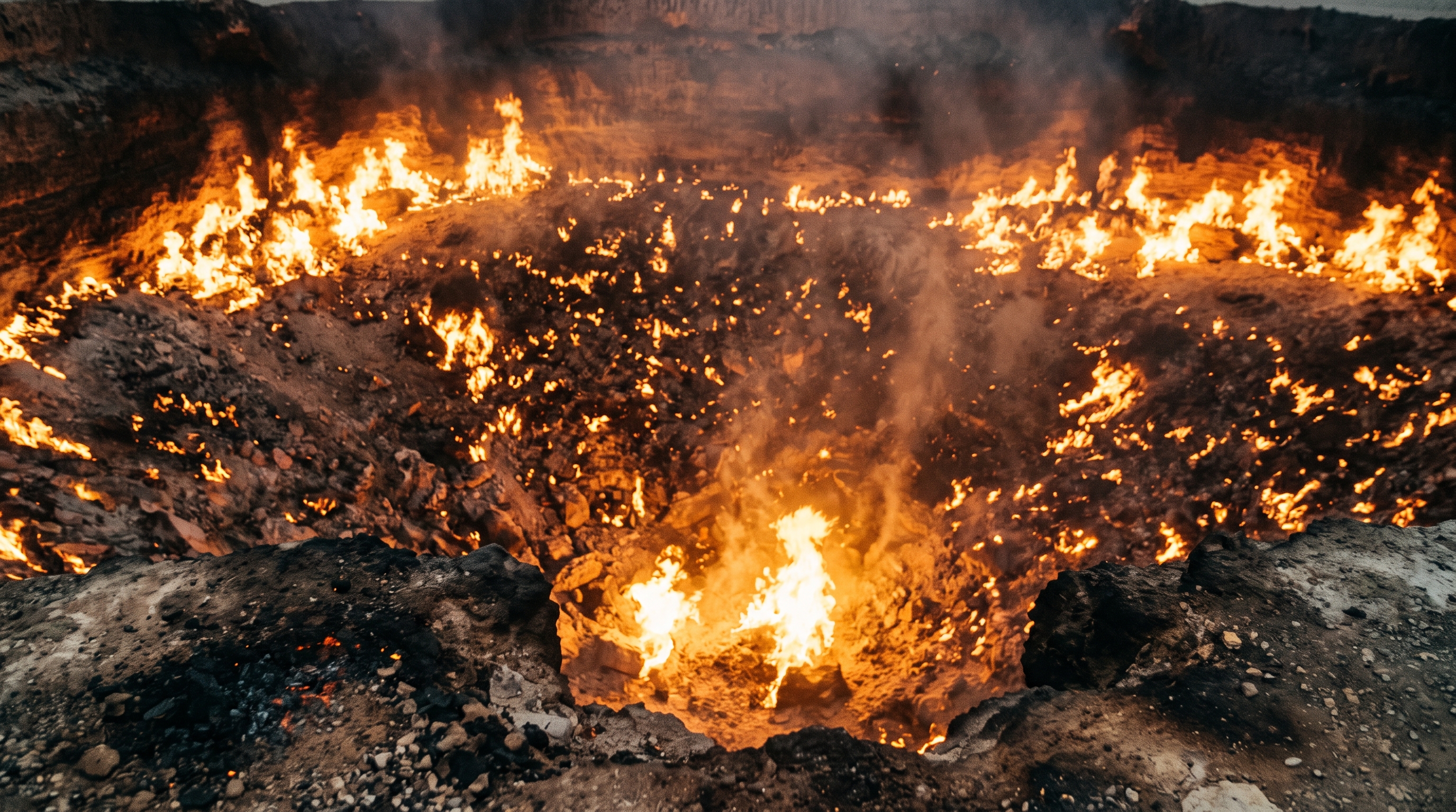 Looking down into the fiery depths of the Darvaza crater with hundreds of glowing gas vents