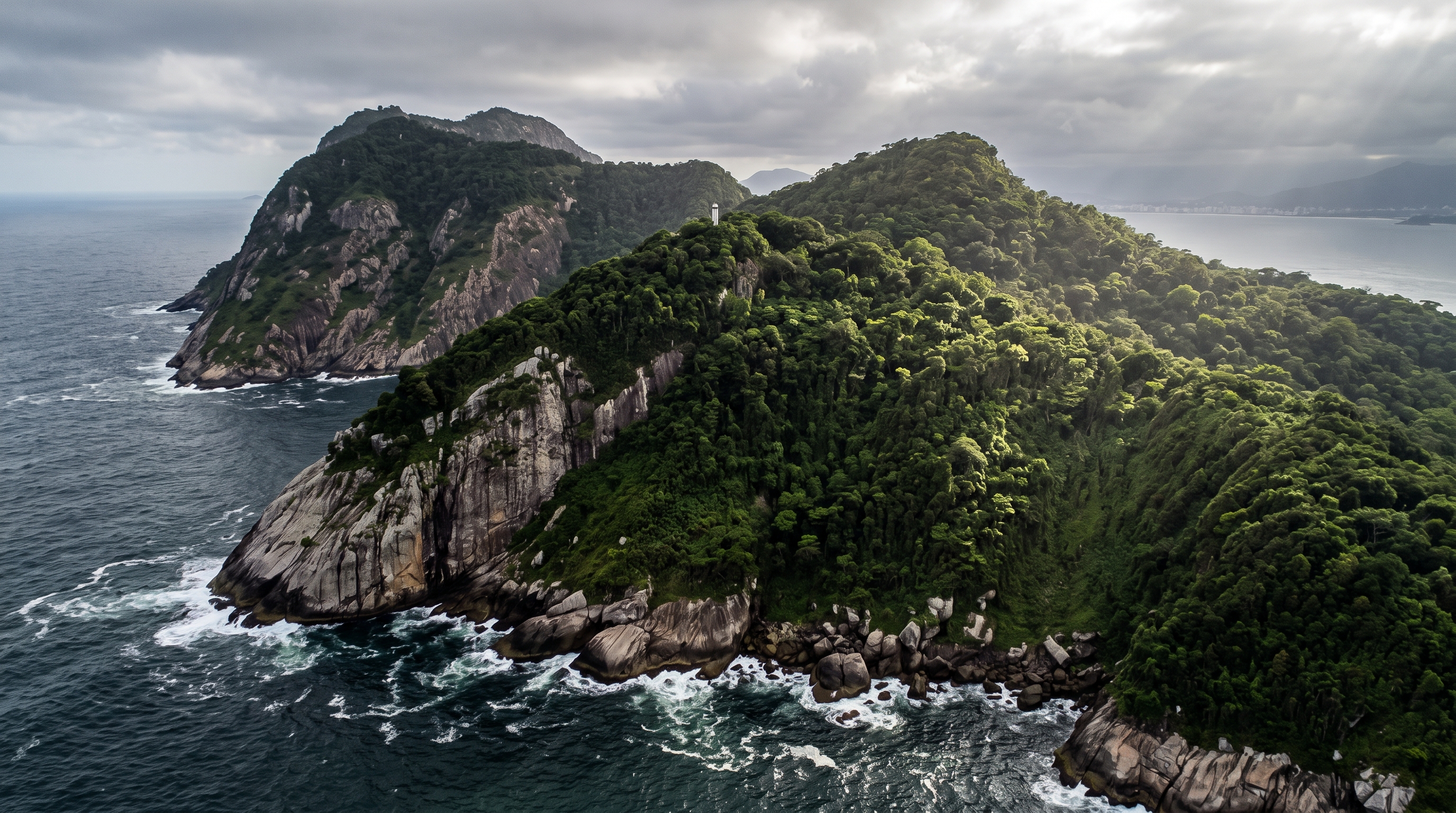 Sheer granite cliffs and dense jungle canopy of Ilha da Queimada Grande rising from the Atlantic ocean